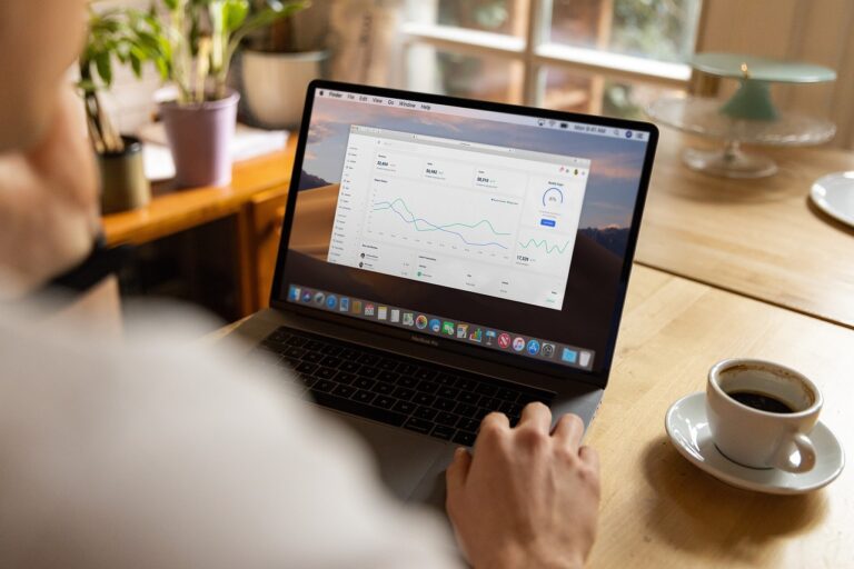 work-life balance - person working on their laptop while enjoying a cup of coffee